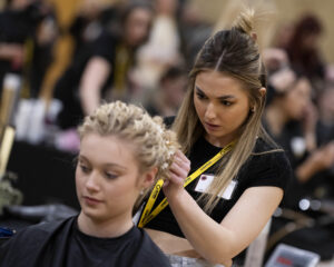 Concept hair magazine, an exhibitor of HairCon, doing a hair demonstration.