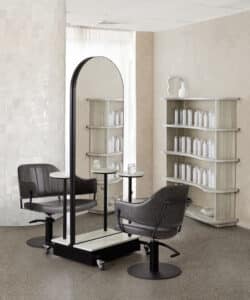 Comfortel Salon featuring two chairs and a mirror. Comfortel is one of the collaborators at HairCon.