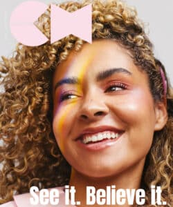 Creative Head magazine cover, with a smiling model in pink. Creative Head are a media partner at HairCon.