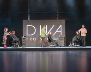 Dive Pro styling doing a demonstration on the live stage at HairCon, Manchester 2024, with stylists Emma Dixon, Alan Bjornson and Michael Gray.