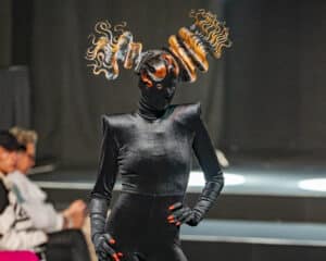 Model showcasing stunning hair creation by Trevor Sorbie's team on the live stage at HairCon, Manchester 2024.